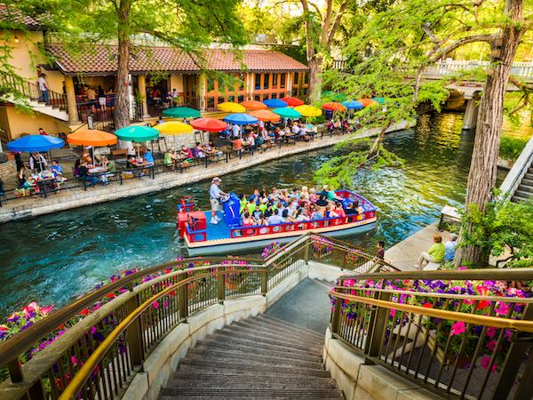 A barge floating on the riverwalk in San Antonio, Texas